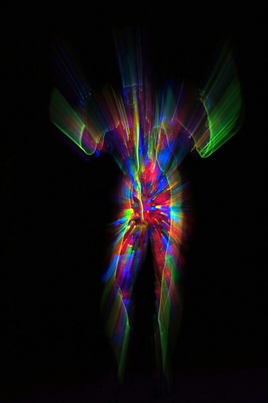 Human figure made of radiant multicolored light